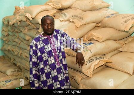 Selingue, Mali, 25th April 2015; Ogobara Kodjo, the Selingue representative of fertilizer company TOGUNA, with sacks of natural phosphate fertilizer. Stock Photo