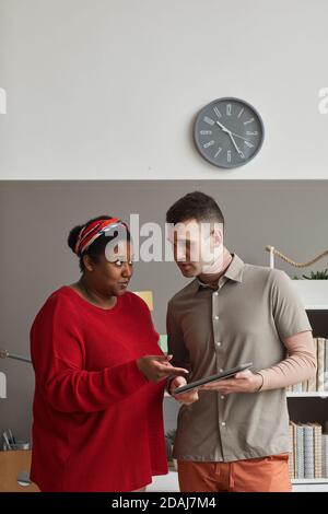 Business couple working online on digital tablet in team at office Stock Photo