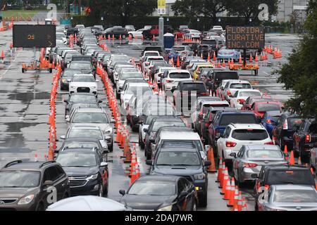 Miami Gardens, FL, USA. 12th Nov, 2020. Cars wait in line at the Coronavirus (COVID-19) drive in testing site, set up in the parking lot of Hard Rock Stadium as Florida reported more than 5,838 new cases of COVID-19 on November 12, 2020 in Miami Gardens, Florida. Credit: Mpi04/Media Punch/Alamy Live News Stock Photo