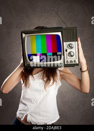 young woman with old retro television on her head Stock Photo