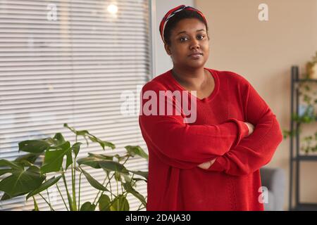 Portrait of African overweight woman standing with arms crossed at office looking at camera Stock Photo