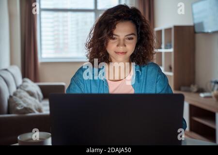 Horizontal photo of young woman freelancer working online on computer laptop. Stock Photo