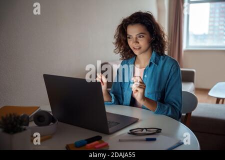 Young woman freelancer working online on computer laptop. Stock Photo