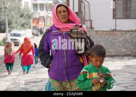 An unidentified woman, of Indian nationality, with a little boy on Jomsoma Street in Nepal, Mustang District. Stock Photo