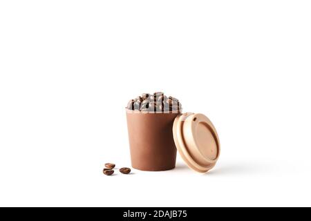 Beautiful takeaway cup made of chocolate filled with coffee beans on isolated white background. Abstract design template on white backdrop. Food and drink concept. Coffee background. Copy space. Stock Photo
