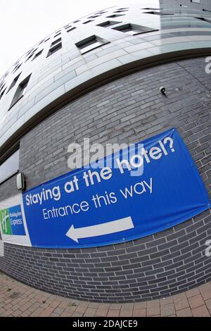 Holiday Inn Express Manchester City Centre Arena from the rear with a sign directing visitors to the entrance. Stock Photo