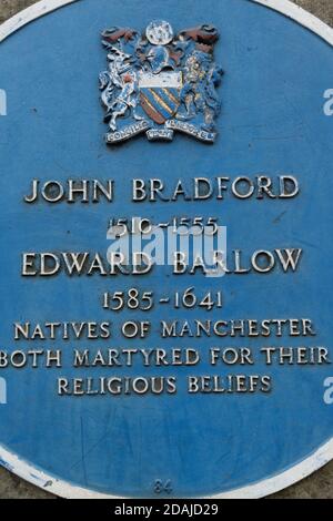 Blue plaque outside Manchester Cathedral in memoriam to religious martyrs from Manchester: John Bradford ( 1510 -1555) and Edward Barlow (1585 -1641).