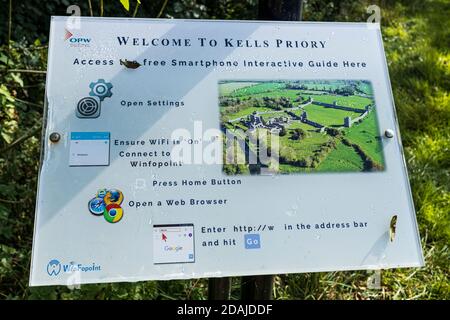 Tourist information sign with QR code at Kells Priory ruins of a fortified Agustine monastary in County Kilkenny, Ireland Stock Photo