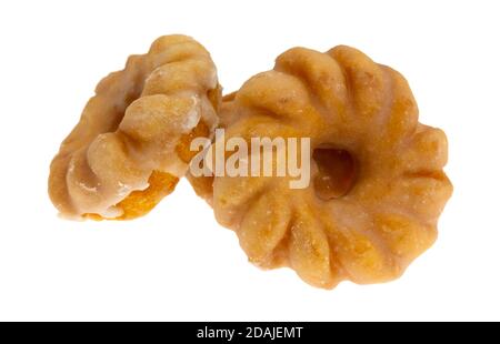 Side view of three glazed bite size crullers on a white background. Stock Photo