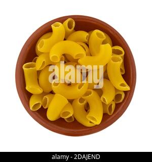 Top view of a bowl of organic elbow macaroni isolated on a white background. Stock Photo