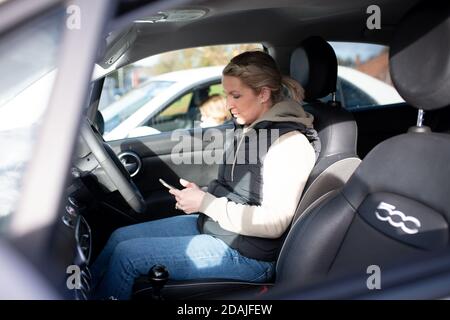 Sarah Key waits for her coronavirus test result in her vehicle at Dimensions Leisure Centre in Stoke-on-Trent during a testing session held by Stoke-on-Trent City Council using the newly-supplied lateral flow Covid-19 tests. Stock Photo