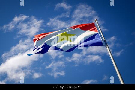 Beautiful national state flag of Saba fluttering at sky background. Low angle close-up Saba flag 3D artwork. Stock Photo