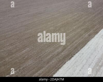 Partially plowed agricultural field, aerial view. Agricultural field, arable land. Background. Stock Photo
