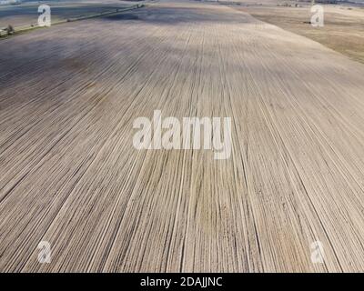 Plowed agricultural field, aerial view. Agricultural land. Stock Photo