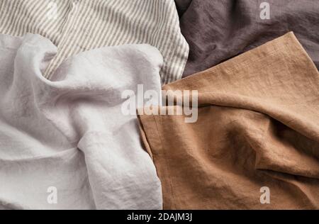 Wrinkled handmade wowen waffle linen cotton napkins fabric background. Different colors brown, gray and striped. Food photo props. Natural waffle line Stock Photo