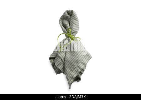 One green linen napkin folded with jute rustic rope with ribbon and greenery plant Stock Photo