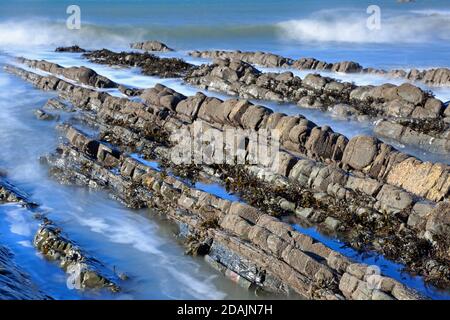 View of the rock ledges at Welcombe Mouth Beach on the Devon and Cornwall border Stock Photo