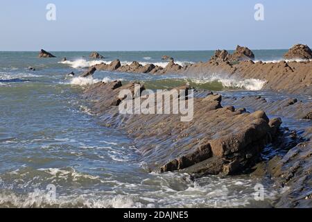 View of the rock ledges at Welcombe Mouth Beach on the Devon and Cornwall border Stock Photo