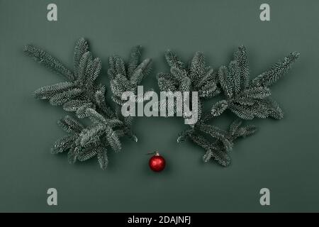Christmas deer face made from fir tree branches and red bauble. Holiday creative concept. Stock Photo