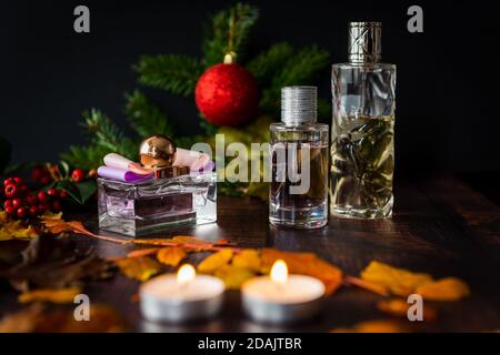 Christmas gifts on a table with decorations and candle lights. Stock Photo