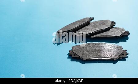 Old brake pads disk brake, isolated on a  background . A car used disc brakes pads. Stock Photo