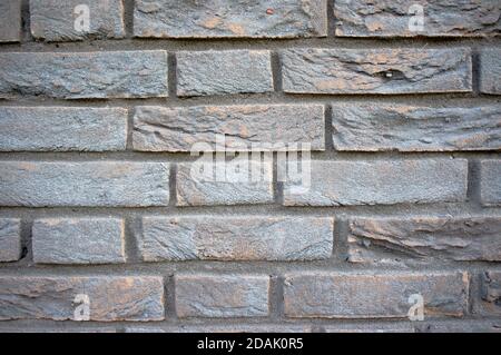 Black decayed stone brick wall background Stock Photo