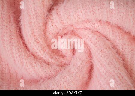 Background of woolen knitted pink warm sweater top view. Cloth sample concept Stock Photo
