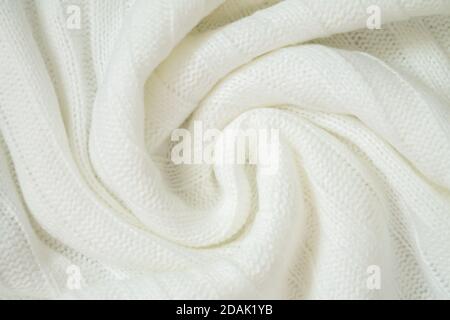 Background of woolen knitted white warm sweater from above. Cloth sample concept Stock Photo