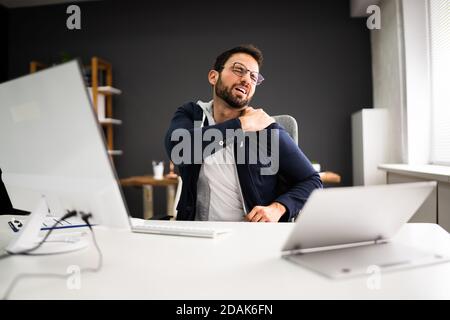 Young Man With Tense Shoulder Pain. Office Posture Problem Stock Photo