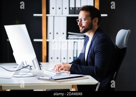 Employee Using Business Computer. Work From Home Stock Photo