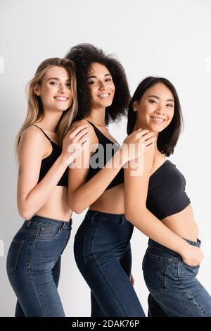 Three Gorgeous Women Posing in Jeans and White Bras