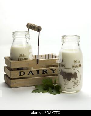 Bottles of milk in a wooden dairy box isolated on a white background Stock Photo