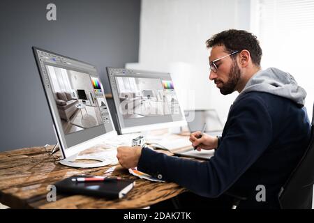 Designer Editing Photos On Multiple Computer Screens Stock Photo