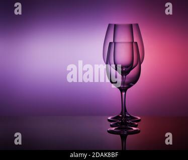 close-Up view Of various empty Glasses Against Colored Background Stock Photo