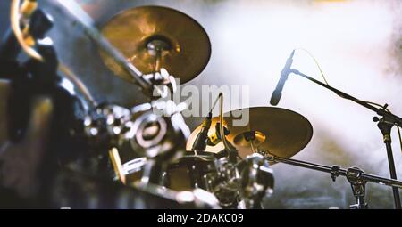 Abstract image of drum on stage and smoke illuminated by spotlights.Live music and nigth concert background