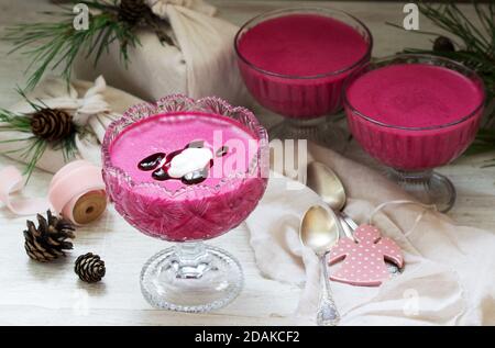 Blackcurrant, orange and cream mousse in a glass bowl. Rustic style, selective focus. Stock Photo