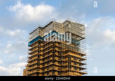 scaffolding on a block of apartments undergoing major refurbishment building work Stock Photo