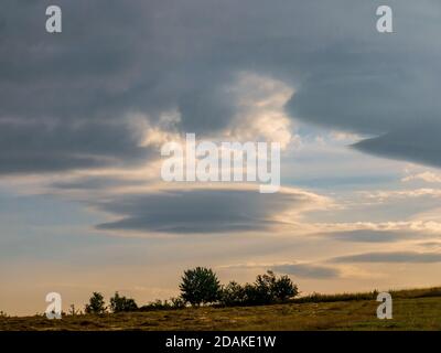 Lenticular cloud - Altocumulus lenticularis - strange cloud in the shape of a UFO in the sky Stock Photo