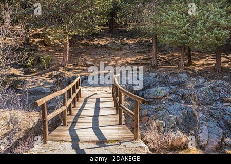 wooden bridge over a stream in the middle of the forest. Guadarrama National Park. Spain. Stock Photo