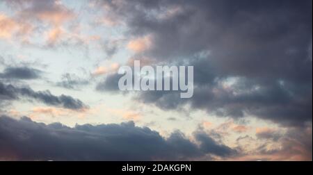 Sunset clouds. Dramatic magical sunrise cloudscape over blue gray color cloudy sky Stock Photo