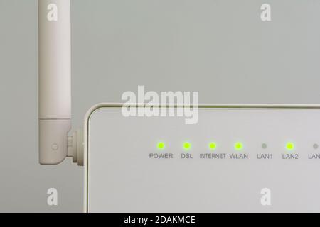 White wireless internet router with antenna isolated on gray background Stock Photo