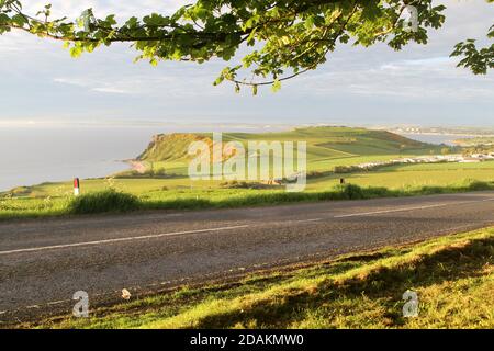 Heads of Ayr, Ayrshire Scotland, UK. View from the A719 across the headland known as the Heads of Ayr . Above a remote sandy beach backed by a low-lying fields in an area dominated by high cliffs. With excellent views out over the Firth of Clyde across to the Isle of Arran, and to the town of Ayr a few miles to the north Stock Photo