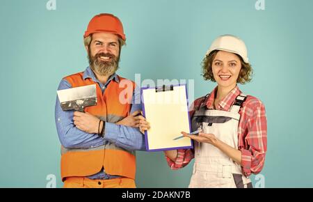 confident electrical and technician. engineers couple working together on building blueprint. work at construction site or factory. Civil engineering. industrial business partner. job and occupation. Stock Photo