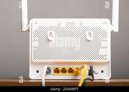 Modern white wireless internet router backside with cables and DSL wire Stock Photo