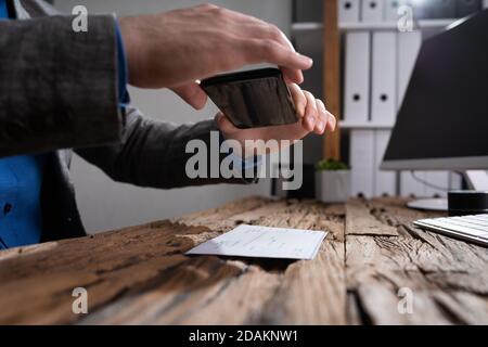 Remote Check Deposit. Scanning Documents Using Mobile Photo Stock Photo