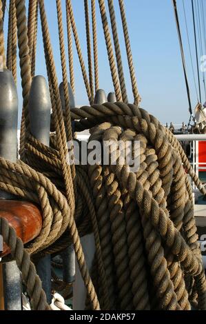 Belaying pins and hemp rope for the standing rigging on The Prince William,a square-rigged brig, sailing across the Atlantic from the Azores to Dingle Stock Photo