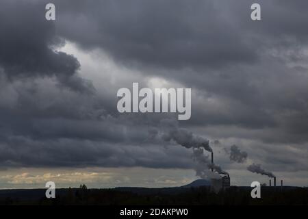 Mount Říp pictured behind the Mělník Power Station (Elektrárna Mělník) in Central Bohemia, Czech Republic. Stock Photo