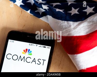 In this photo illustration a Comcast logo is seen displayed on a smartphone. Stock Photo