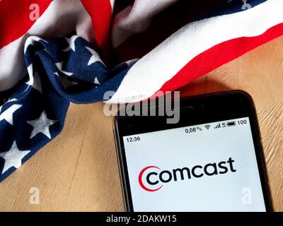 In this photo illustration a Comcast logo is seen displayed on a smartphone. Stock Photo