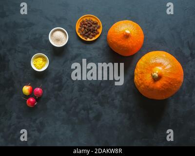 Pumpkin before baking on a black table. Preparation of pumpkin dessert. Stock Photo